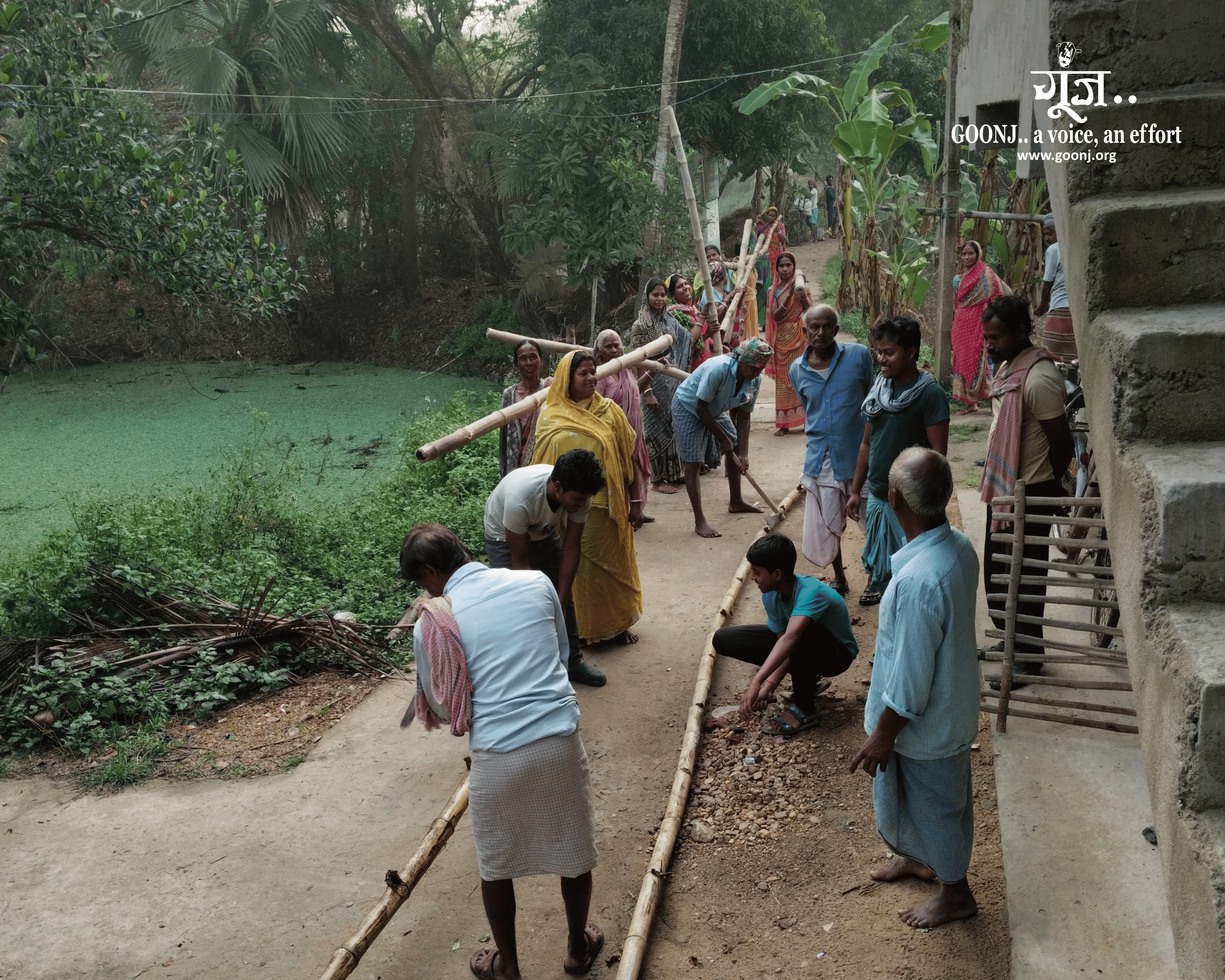 Maharajpur residents carry locally sourced bamboo to build a bridge across the Ketha River.