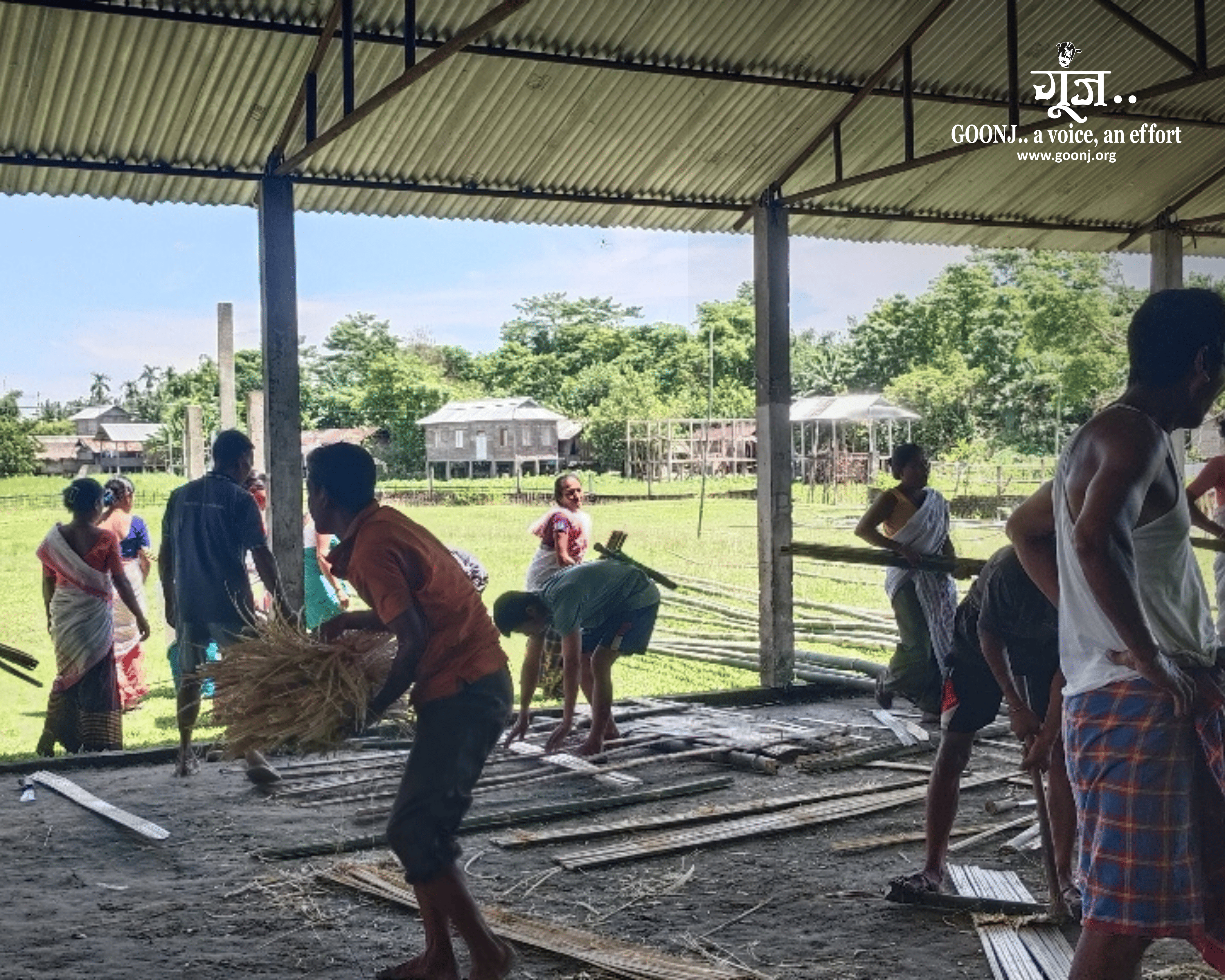 Parents, teachers and villagers in Lachan Gaon rebuild walls and fencing at Brahmaputra High School using bamboo and local materials.